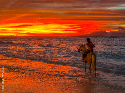 Horse riding during sunset in Gili Trawangan beach in Lombok, Indonesia