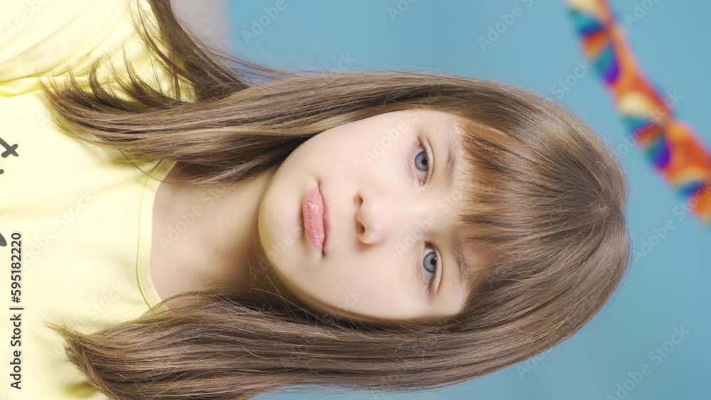 Vertical Video of Unhappy and sullen little girl looking at camera. Vertical Video of Unhappy and sullen little girl looking at camera.