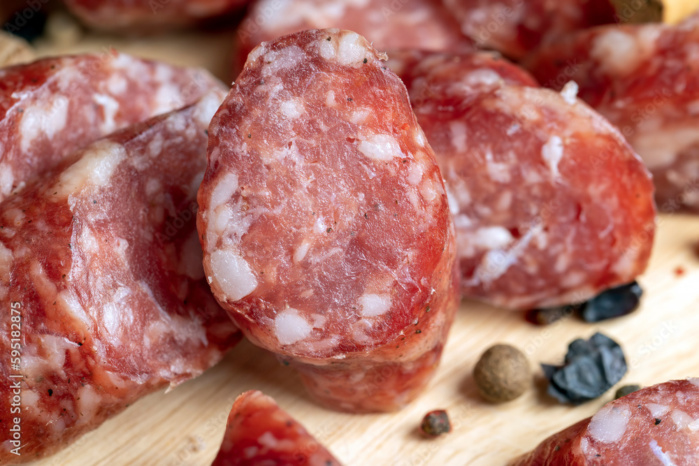 Dried veal sausage during slicing Dried veal sausage during slicing