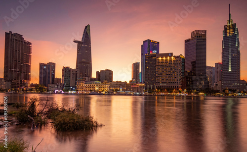 The sunset sun shines on buildings in downtown Ho Chi Minh city, Vietnam.