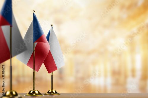 Small flags of the Czechia on an abstract blurry background
