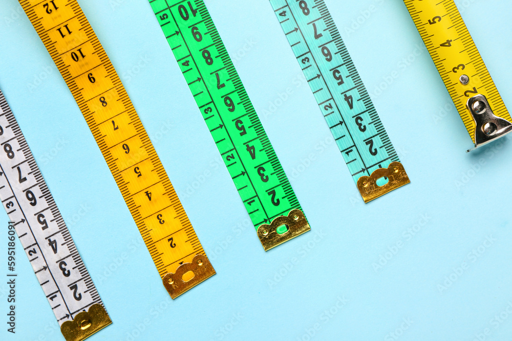 Colorful measuring tapes on blue background Colorful measuring tapes on blue background