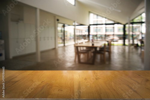 Empty wooden table in front of abstract blurred background of coffee shop . can be used for display or montage your products.Mock up for display of product © Charlie's