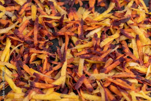 Sliced into thin slices of red-orange carrots in the kitchen