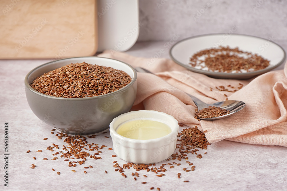 Bowl with flax oil and seeds on light background Bowl with flax oil and seeds on light background