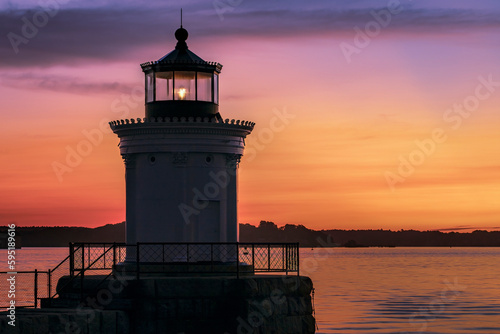 Bug Light, also known as Bug Lighthouse in Portland, Maine, at sunrise with a colorful sky, and condensation on the glass of the lighthouse