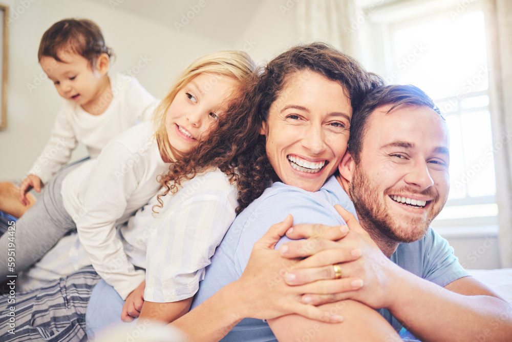 Family, portrait and happy smile in a home bedroom with children and parents together on bed for quality time. Man and woman or mother and father with children for happiness, love and care in morning