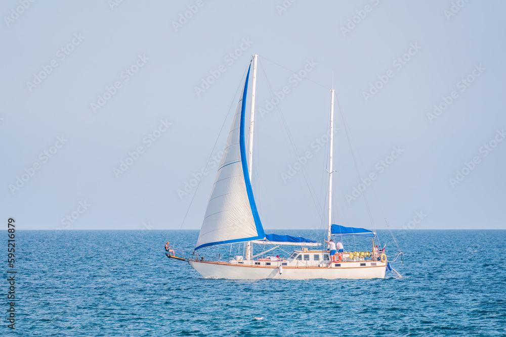 Sailing yacht in the blue calm sea.