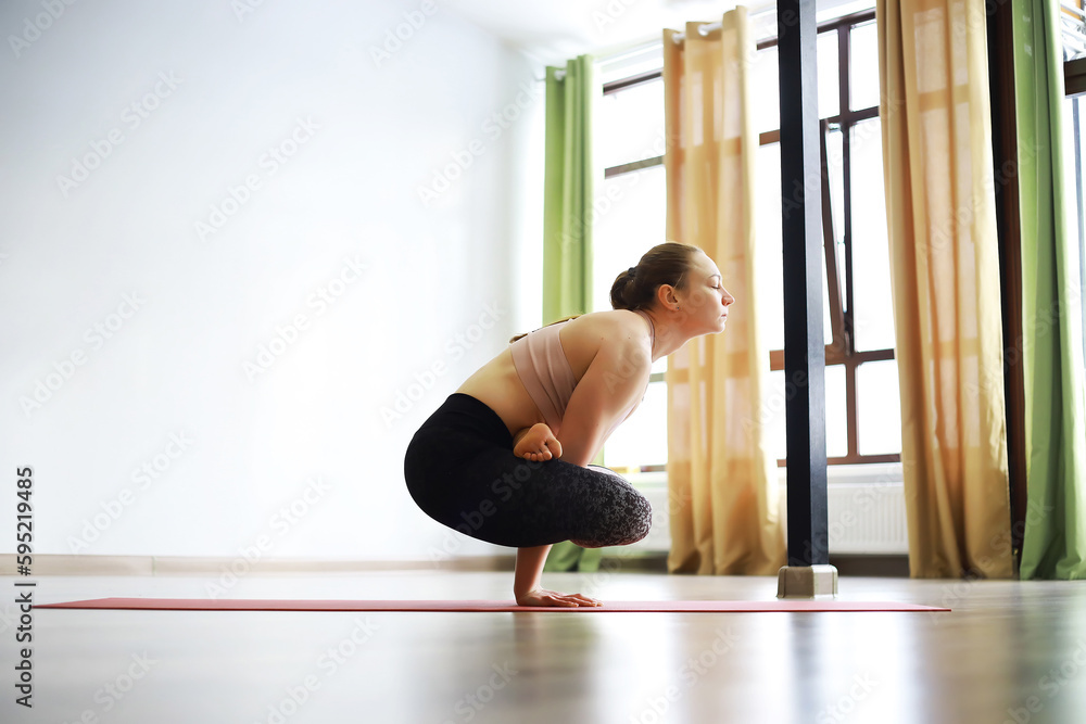 Girl doing yoga in the studio
