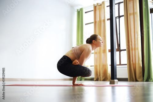 Girl doing yoga in the studio