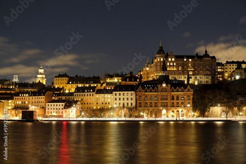 Beautiful scenery of illuminated Stockholm waterfront view towards Sodermalm district with historic Mariahissen building and Monteliusvagen  Sweden 