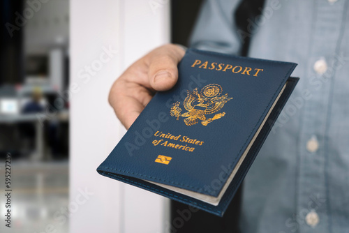 hand holding passport with bokeh background, jorney and travel concept. Passport check at the border. A man will find a passport for obtaining a visa at airport. photo