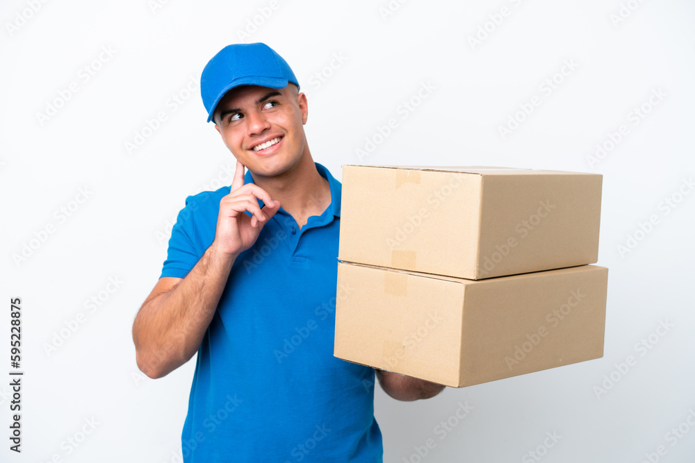 Delivery caucasian man isolated on white background thinking an idea while looking up Delivery caucasian man isolated on white background thinking an idea while looking up