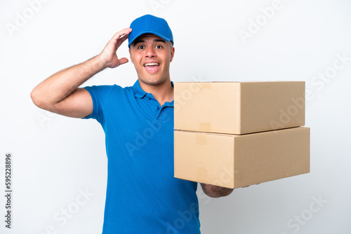 Delivery caucasian man isolated on white background with surprise expression © luismolinero