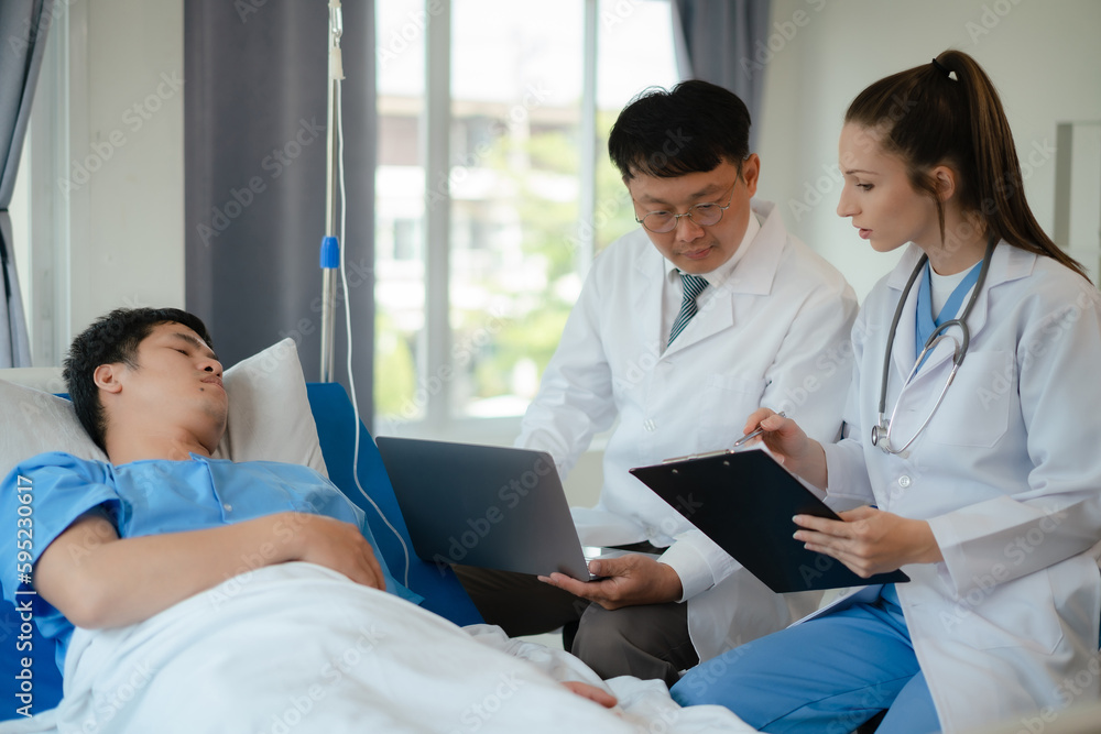 Fototapeta premium doctor team talking with man patient for monitoring and check up after surgery. doctor touching patient hand and consoling.