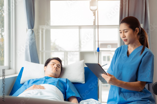 medicine, healthcare and people concept - doctor talking to male patient at bed in hospital.