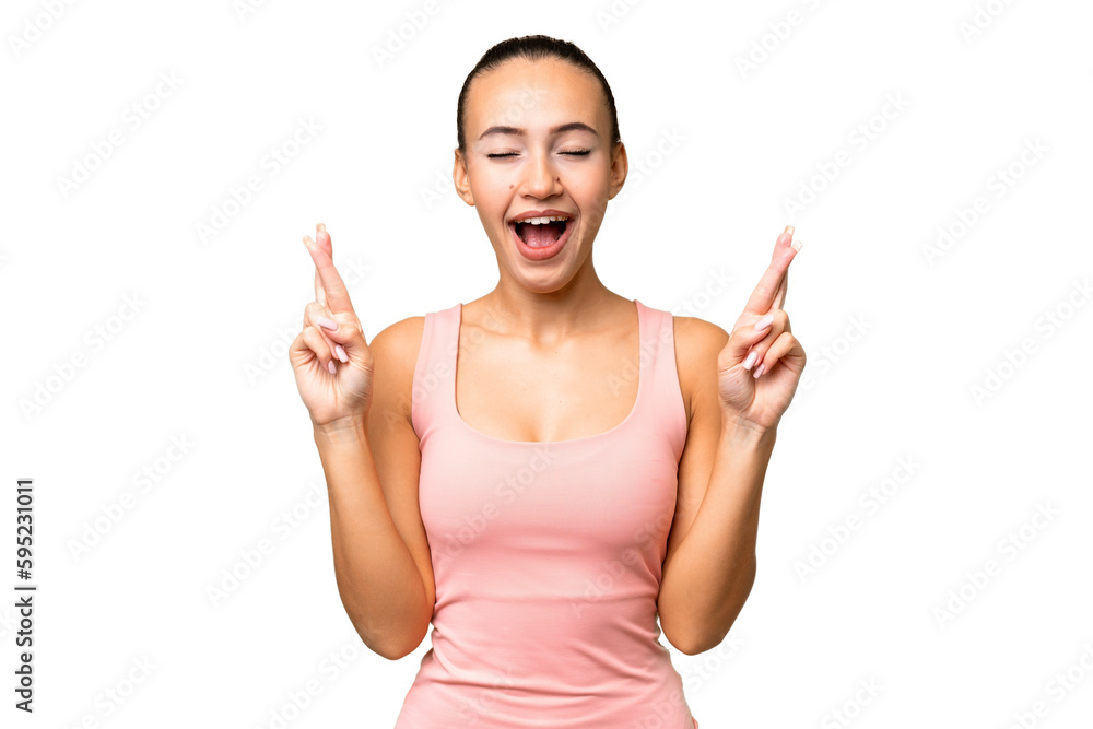 Young Arab woman over isolated background with fingers crossing Young Arab woman over isolated background with fingers crossing