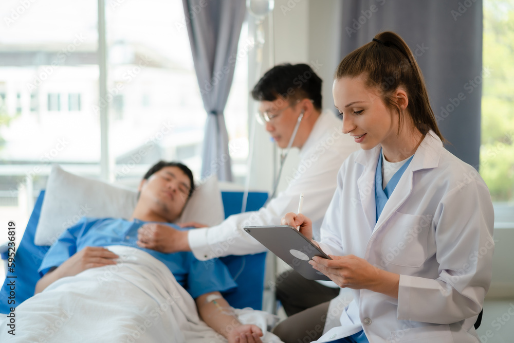 doctor team talking with man patient for monitoring and check up after surgery. doctor touching patient hand and consoling. doctor team talking with man patient for monitoring and check up after surgery. doctor touching patient hand and consoling.
