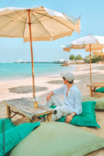 Daytime atmosphere Scaffolding cafe, white sandy beach, seaside, clear water, Koh Lan Tropical Beach, Pattaya City, Chonburi, Thailand © Nichapa