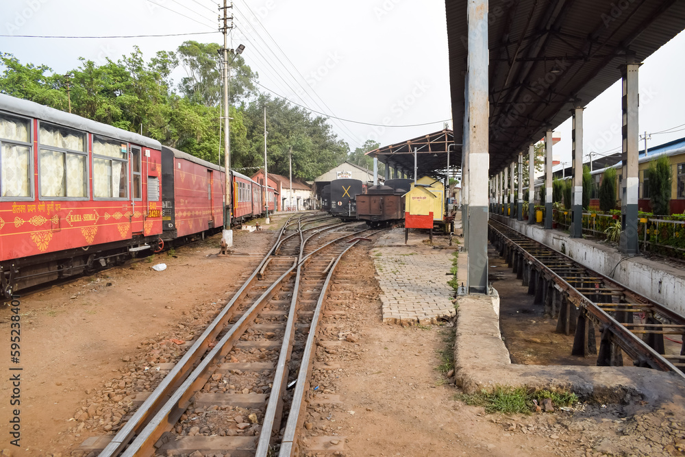 Obraz premium View of Toy train Railway Tracks from the middle during daytime near Kalka railway station in India, Toy train track view, Indian Railway junction, Heavy industry