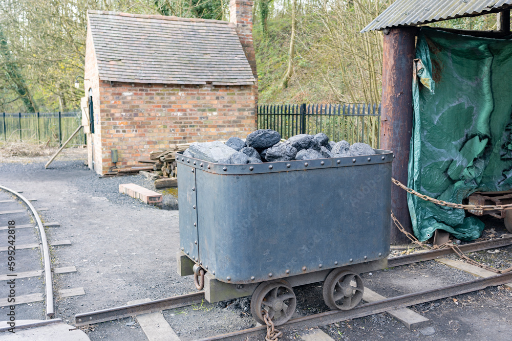 factory coal tub or trolley on tracks filled with coal factory coal tub or trolley on tracks filled with coal