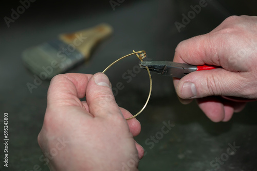 Jewelry master at work on the manufacture of a gold ring. Jewelry factory.