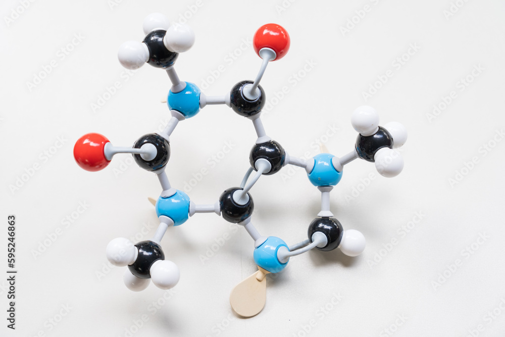Obraz premium Caffeine (or theine) molecule made by molecular model on white background. Coffee and tea chemical formula with colored atoms and bonds
