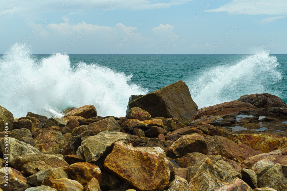 Rocky shore of the ocean and splashes from the waves Rocky shore of the ocean and splashes from the waves
