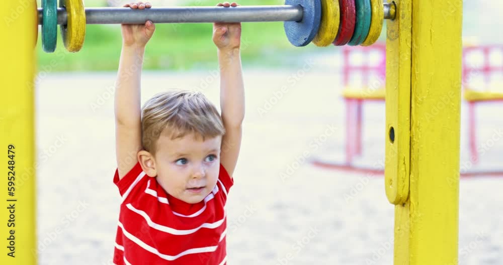 Happy smiling boy having fun on the playground. Kids leisure activity Happy smiling boy having fun on the playground. Kids leisure activity