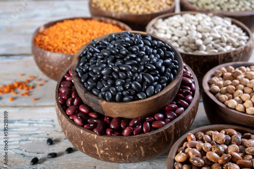 close up dried legumes black beans in wooden bowl