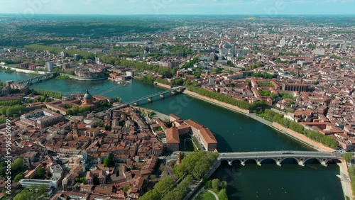 Toulouse city and Garonne river aerial panoramic view. It's the capital of southern France Occitanie region. Historical landmark Dome de La Grave from above in Haute Garonne on a summer day 4K UHD