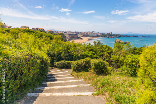 Rocky steps and view of Biarritz seen from the Pointe Saint-Martin on a sunny day in France