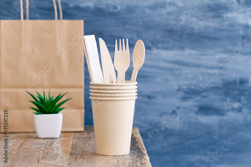 Zero waste, plastic free,recyclable, sustainable utensils including fork, spoon, knife, cups, napkin and a bag with copy space. Can be used as a food delivery ad...