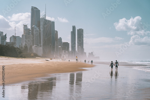 Surfers Paradise, Gold Coast, Australia - People walking along the beach with highrises in the background