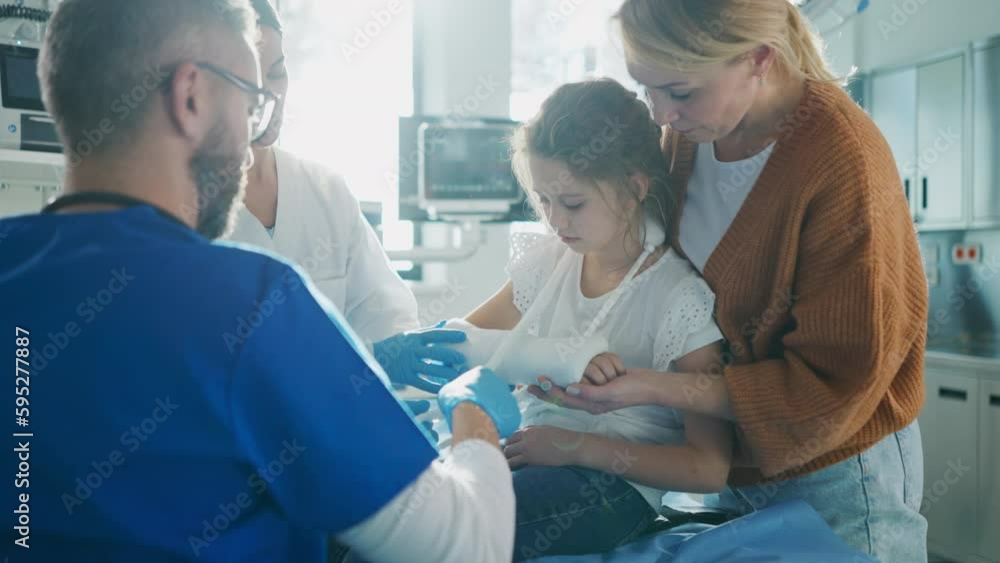 Mature doctor giving gypsum to little girl. Mature doctor giving gypsum to little girl.