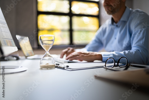 Late Invoice And Billing Deadline With Hourglass photo