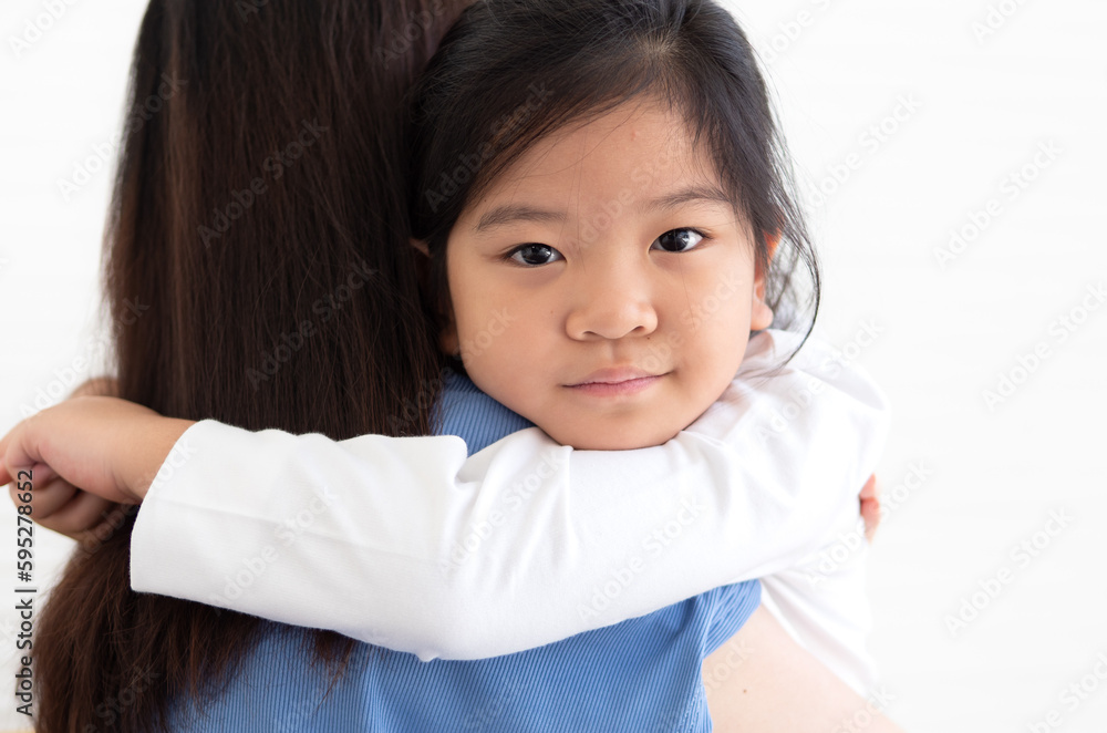 Cute little girl happy hug her mother. Portrait of Asian family, daughter and mom sweet hugging playing with love and care. Cheerful childhood lifestyle. Beautiful motherhood and child relationship Cute little girl happy hug her mother. Portrait of Asian family, daughter and mom sweet hugging playing with love and care. Cheerful childhood lifestyle. Beautiful motherhood and child relationship