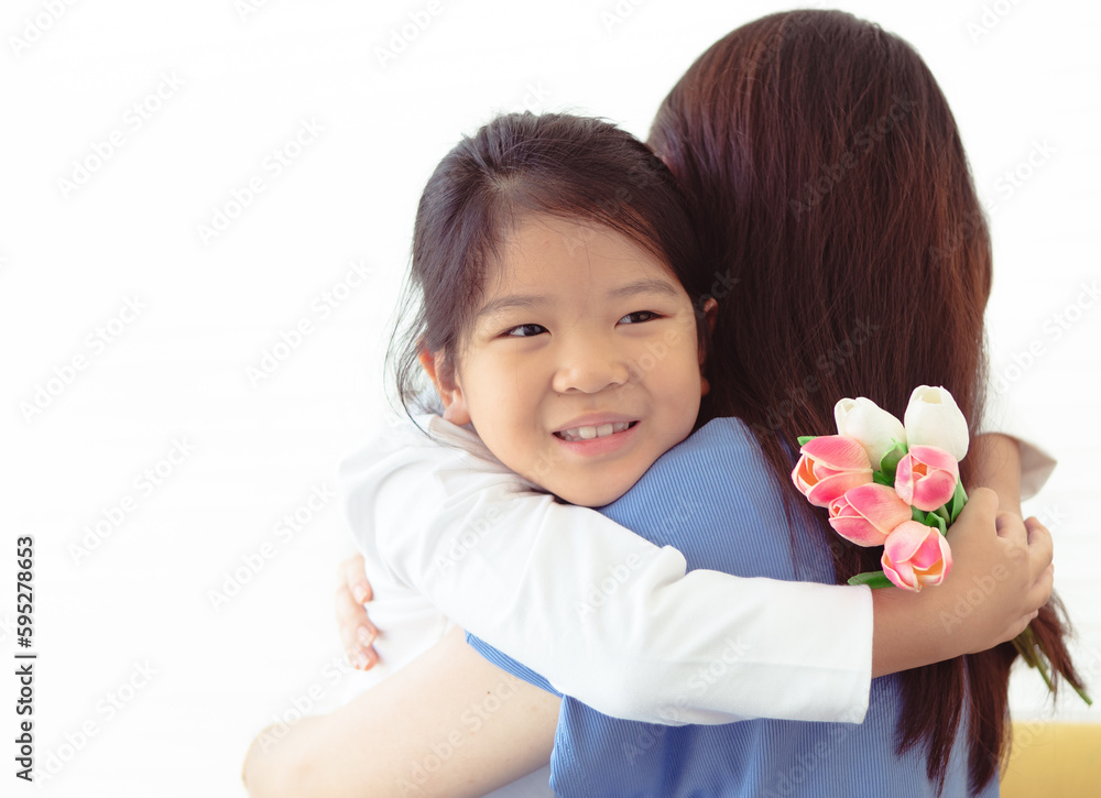 Cute little girl happy hug her mother. Portrait of Asian family, daughter and mom sweet hugging playing with love and care. Cheerful childhood lifestyle. Beautiful motherhood and child relationship Cute little girl happy hug her mother. Portrait of Asian family, daughter and mom sweet hugging playing with love and care. Cheerful childhood lifestyle. Beautiful motherhood and child relationship
