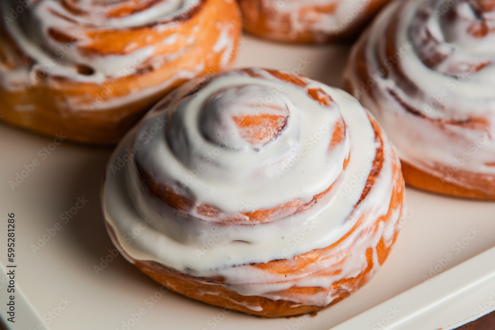 Fototapeta premium Sweet buns covered with white cream. Confectionery.