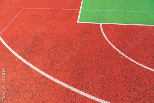 Outdoor basketball field. Detail of red outdoor basketball court