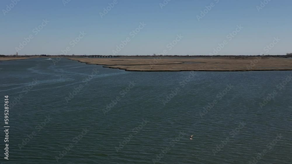 Drone view over the salt marshes coastline by shiny water in Freeport, New York in the summer Drone view over the salt marshes coastline by shiny water in Freeport, New York in the summer