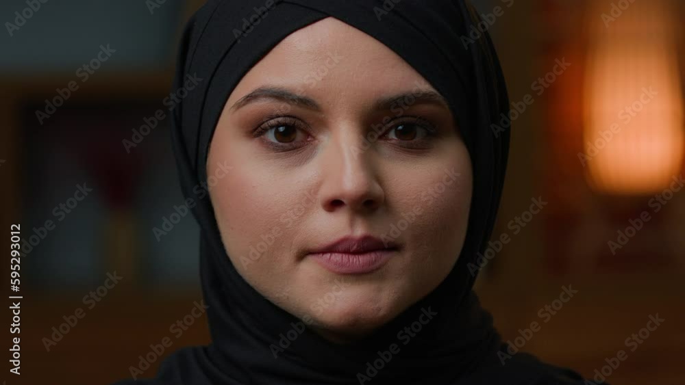 Head shot Arabian Muslim woman islamic young girl in black hijab middle-eastern oriental lady islam religion. Close up face in headscarf beauty makeup skincare. Unhappy saudi female portrait at home Head shot Arabian Muslim woman islamic young girl in black hijab middle-eastern oriental lady islam religion. Close up face in headscarf beauty makeup skincare. Unhappy saudi female portrait at home