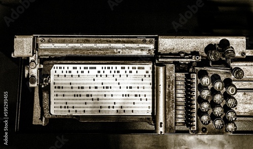 Grayscale shot of an old punch card machine photo