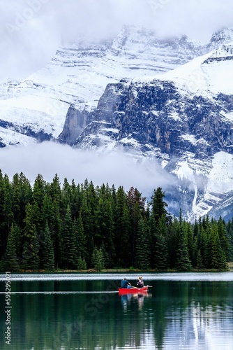 Couple rowing a boat on Two Jack Lake in Alberta, Canada