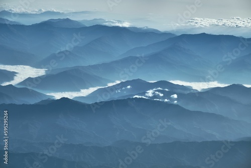Beautiful scene of mountains with white clouds drifting overhead