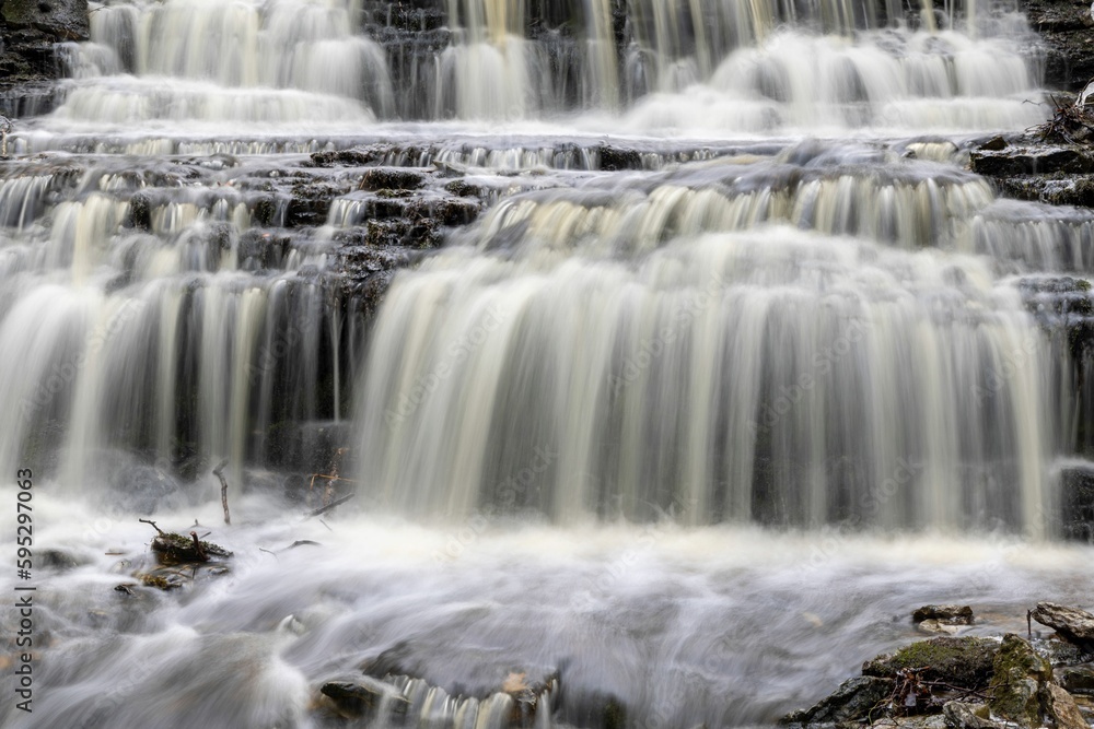 Idyllic river landscape featuring a rocky riverbed and surrounding boulder-strewn banks