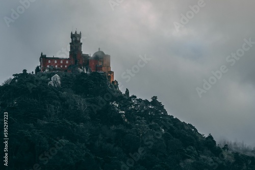A beautiful shot of the Pena Palace on Sintra Mountain on a foggy gloomy day