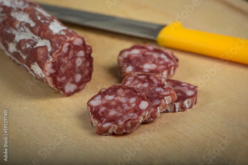view of dry sausage on cutting board