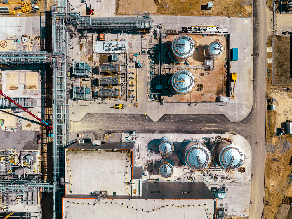 Construction site from above. Top view of factory under construction with heavy machinery. Picture made by drone from above. Construction site from above. Top view of factory under construction with heavy machinery. Picture made by drone from above.