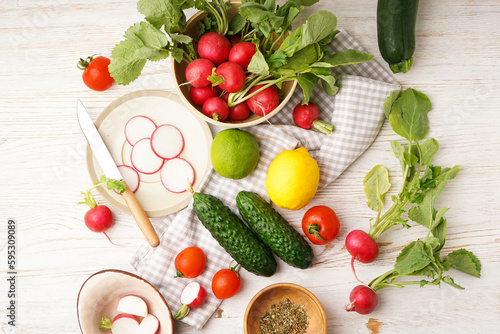 Radish and other spring vegetables on a wooden background  top view.